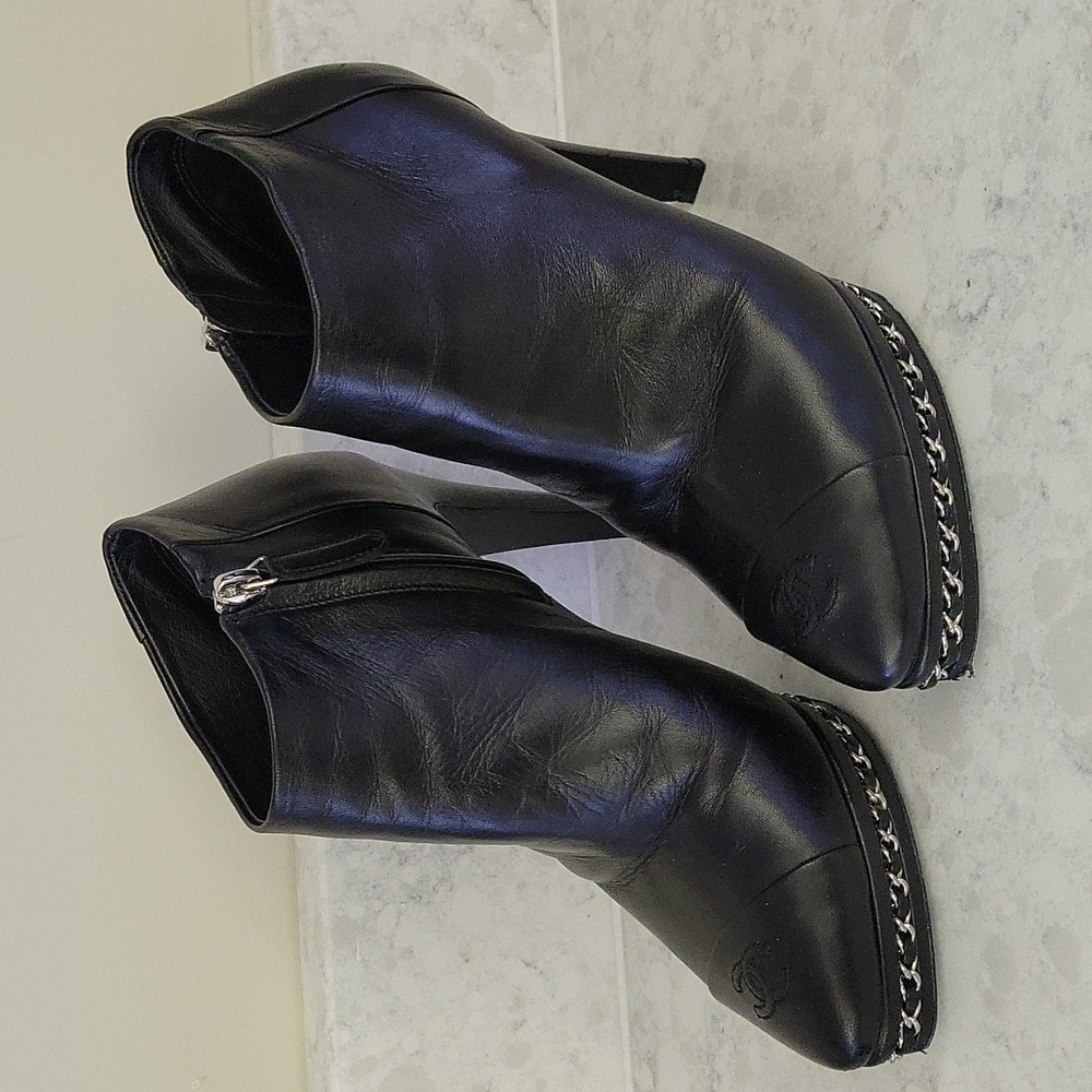 Chanel logo black leather booties with silver chain detail. Size 37.